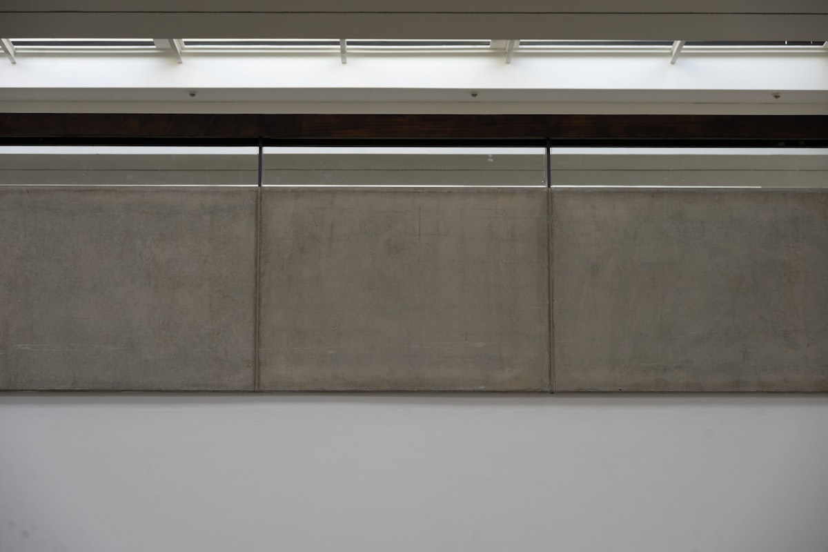 Three concrete panels under fluorescent lights. related to Elevate Your Dining Space with a Wall Mounted Sideboard