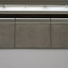 Three concrete panels under fluorescent lights. related to Elevate Your Dining Space with a Wall Mounted Sideboard