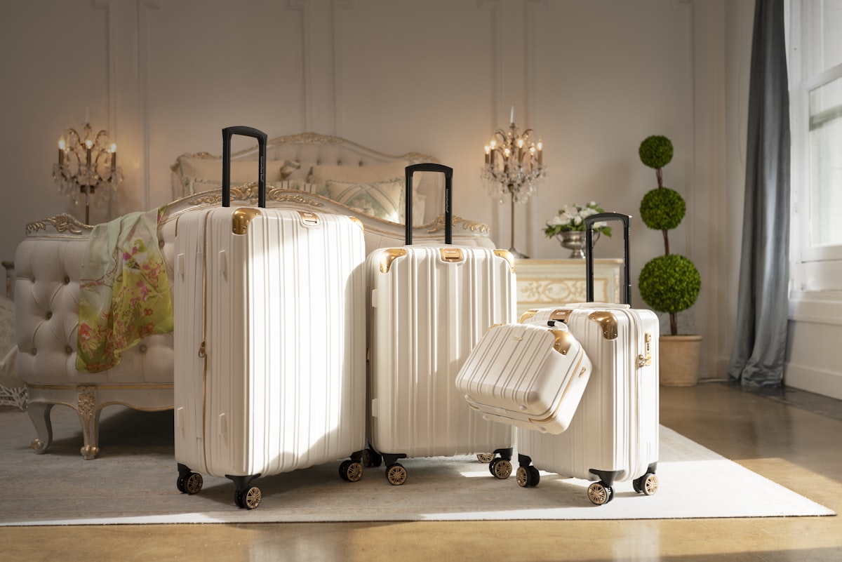 three pieces of white luggage sitting in a room related to Packing Perfection: Your Guide to Bed Bath & Beyond Luggage