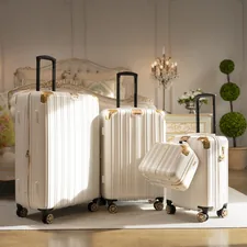 three pieces of white luggage sitting in a room related to Packing Perfection: Your Guide to Bed Bath & Beyond Luggage