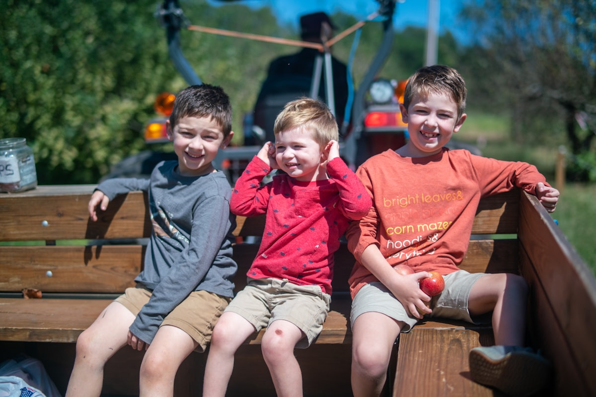 three young boys sitting in the back of a truck related to Exploring the Best Truck Beds in Hillsboro