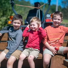 three young boys sitting in the back of a truck related to Exploring the Best Truck Beds in Hillsboro