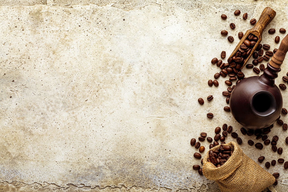 Top view mockup coffee beans on light stone. White paper sheet copy space with vignette related to Coffee Themed Valances