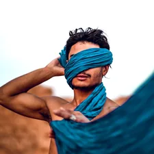topless man holding blue textile related to 10 Creative Scarf Valance Ideas to Elevate Your Window Style