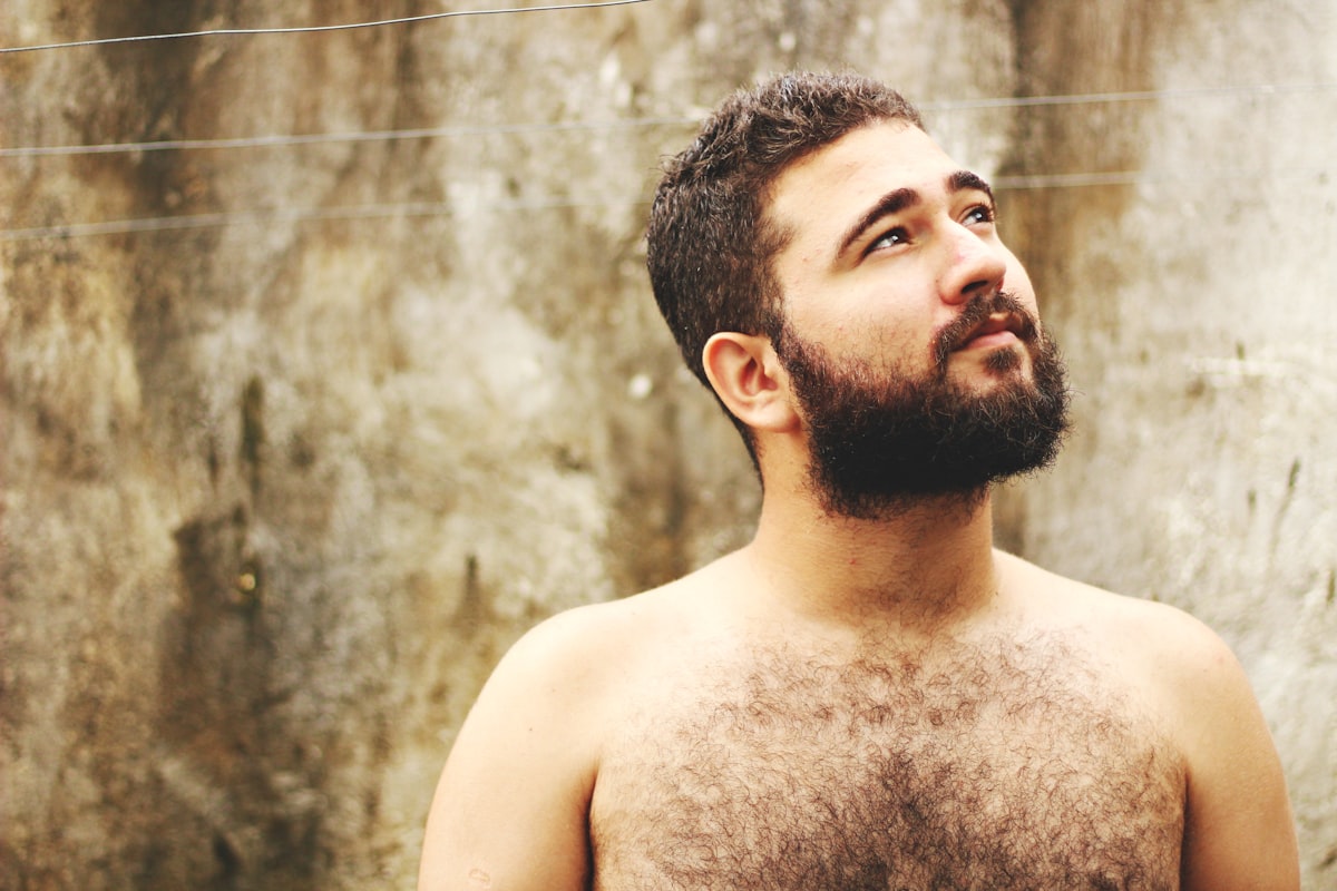 topless man near beige wall related to What Men Really Mean by 'What Do Men Want in Bed'?