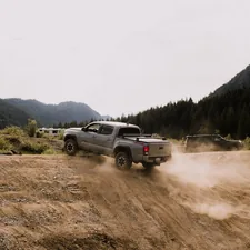 Toyota Tacoma driving off road in the Pacific Northwest in Washington related to Benefits of a Tacoma Bed Cage Installation
