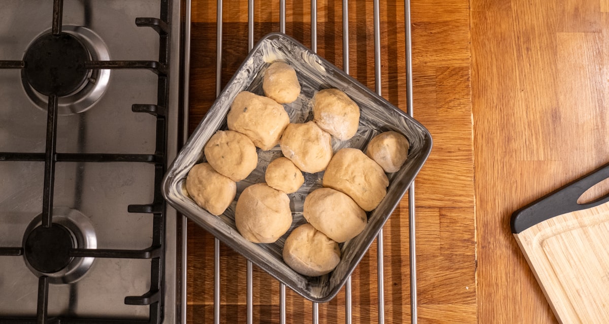 Tray of dinner rolls on a wooden counter. related to Elevate Your Gardening: A Step-by-Step Guide on How to Make a Raised Garden Bed
