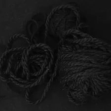 two balls of yarn on a black surface related to Snuggle Up in Style: Unraveling the Mystery of Duvet Coverlets
