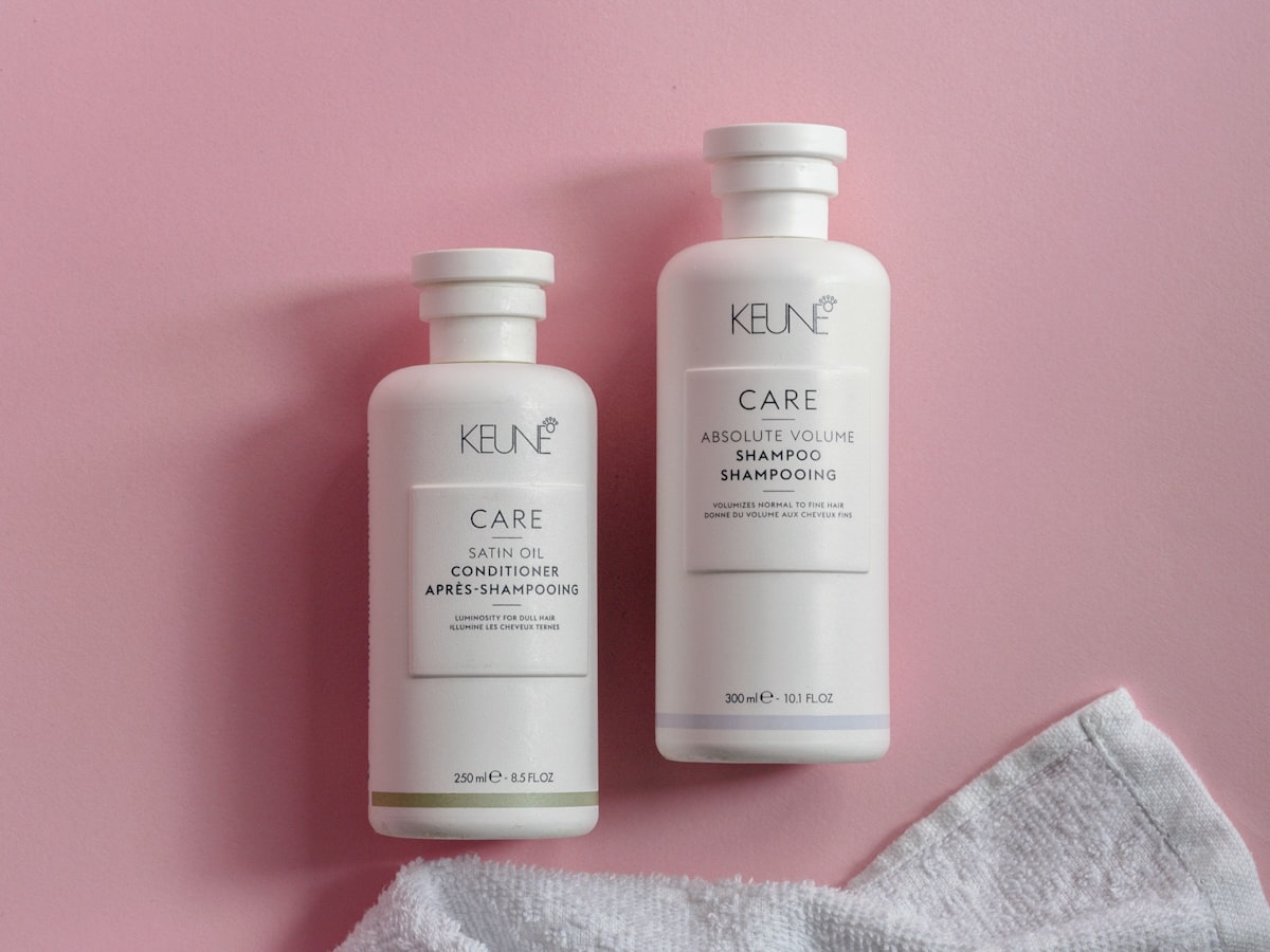 two bottles of keune hair care on a pink background related to Say Goodbye to Bed Head: The Ultimate Guide to Shampoo and Conditioner