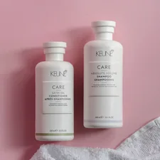 two bottles of keune hair care on a pink background related to Say Goodbye to Bed Head: The Ultimate Guide to Shampoo and Conditioner