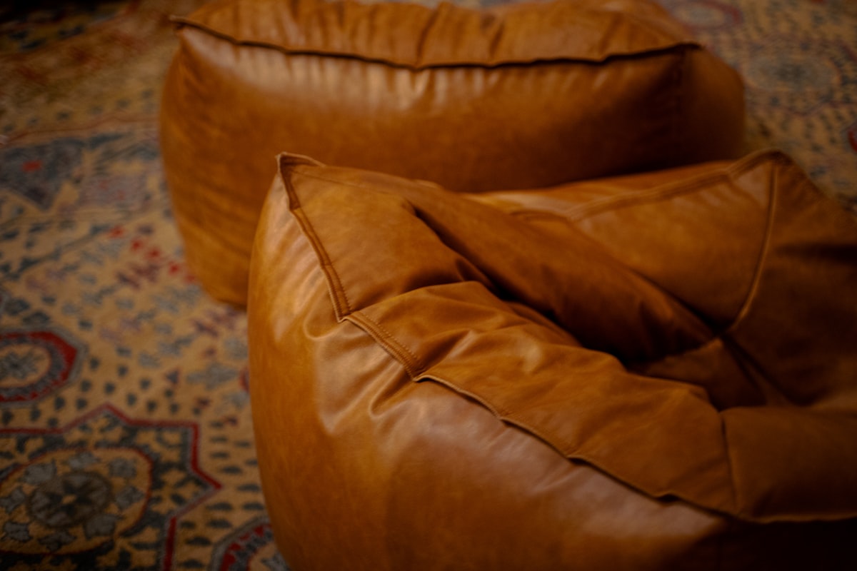 Two brown leather beanbag chairs. related to The Ultimate Comfort Experience: Giant Bean Bag Beds