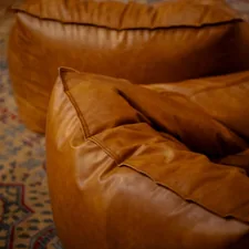 Two brown leather beanbag chairs. related to The Ultimate Comfort Experience: Giant Bean Bag Beds