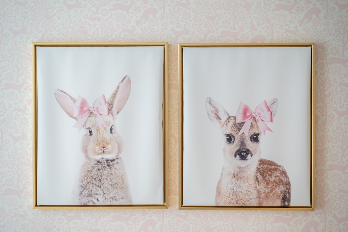Two framed animal art prints with pink bows. related to Fawn-tastic Slumber: Deer Nursery Bedding Ideas