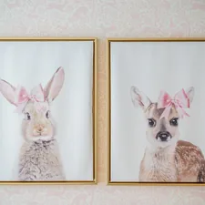 Two framed animal art prints with pink bows. related to Fawn-tastic Slumber: Deer Nursery Bedding Ideas