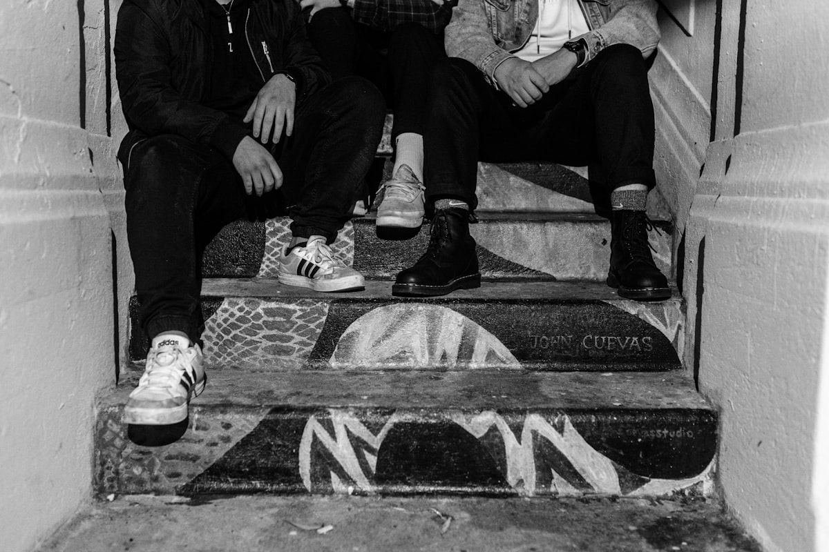two men sitting on the steps of a building related to Step into the Infamous Lizzie Borden Bed and Breakfast
