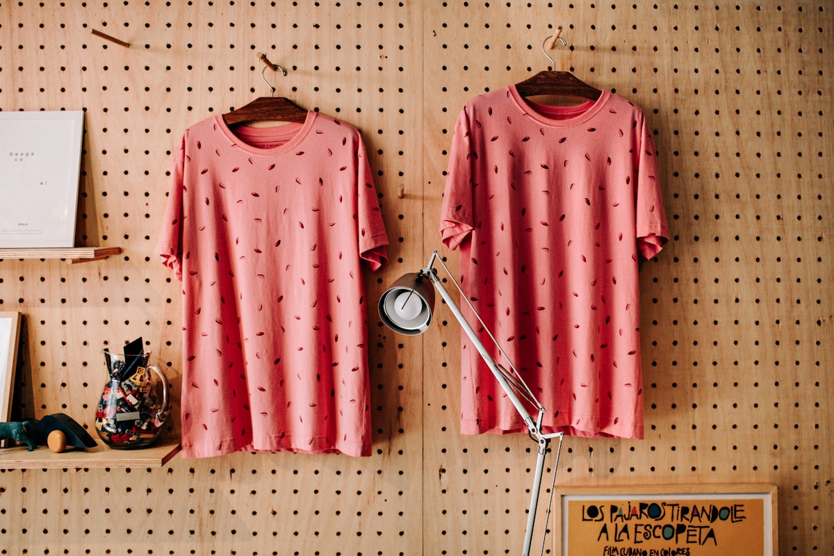 two red-and-black foliage crew-neck T-shirts hanging on hanger related to Pink Polka Dot Valance: A Fashion Statement for Your Home