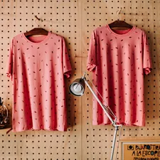 two red-and-black foliage crew-neck T-shirts hanging on hanger related to Pink Polka Dot Valance: A Fashion Statement for Your Home