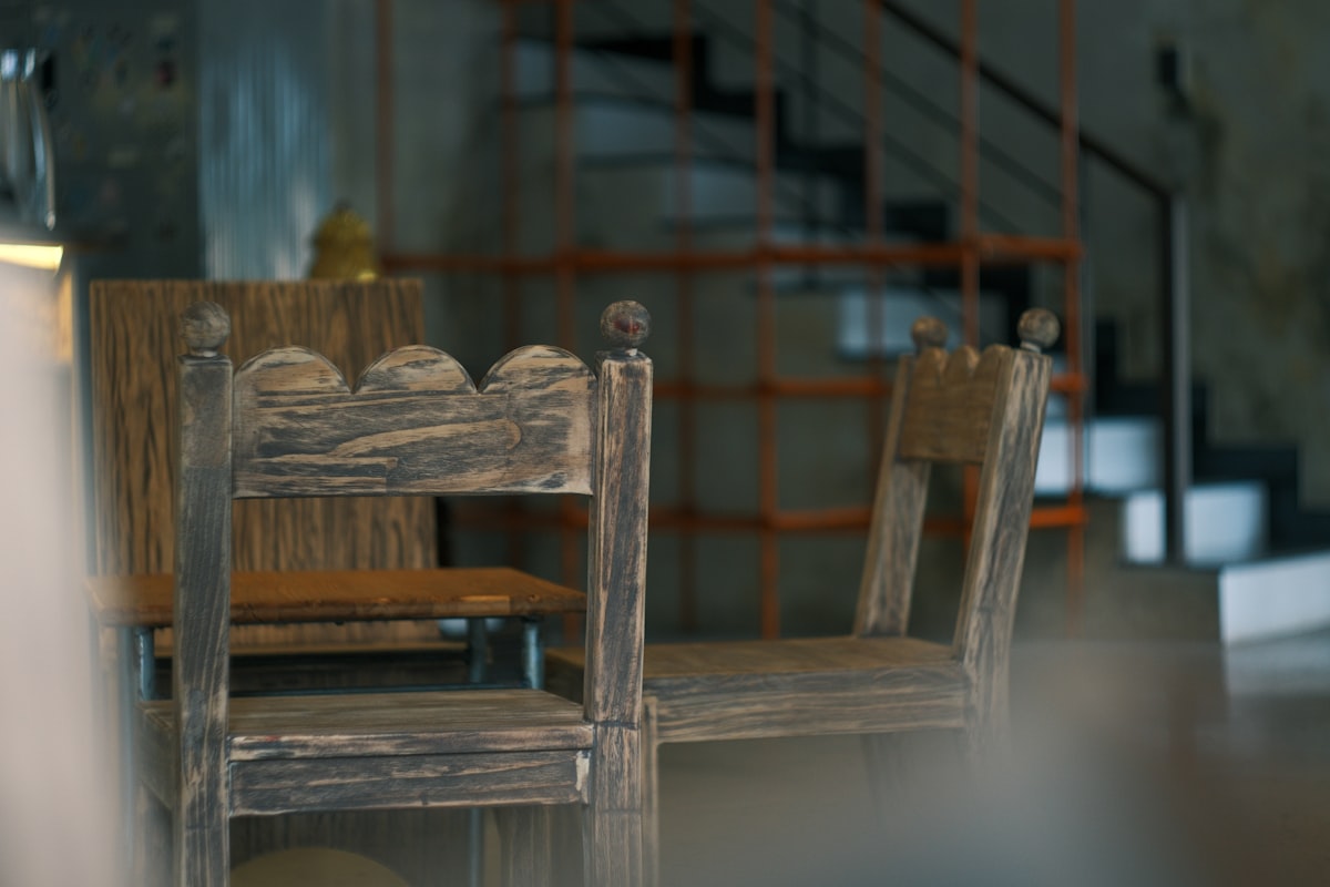 Two rustic wooden chairs in a dimly lit room. related to Elevate Your Home's First Impression with an Entryway Bench with Back