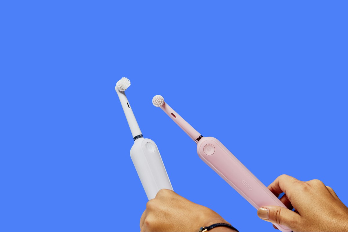 two white electric toothbrushes related to Mastering the Bidet: A Complete Guide for First-Time Users