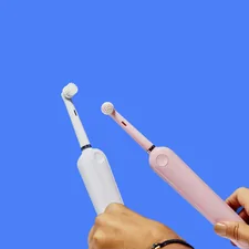 two white electric toothbrushes related to Mastering the Bidet: A Complete Guide for First-Time Users