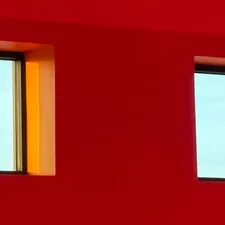 Two windows on a vibrant red wall related to Solid Color Valances for Windows