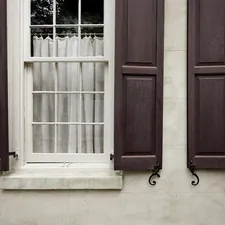 two windows with brown shutters and curtains related to Elevate Your Windows with Elegant Window Valances