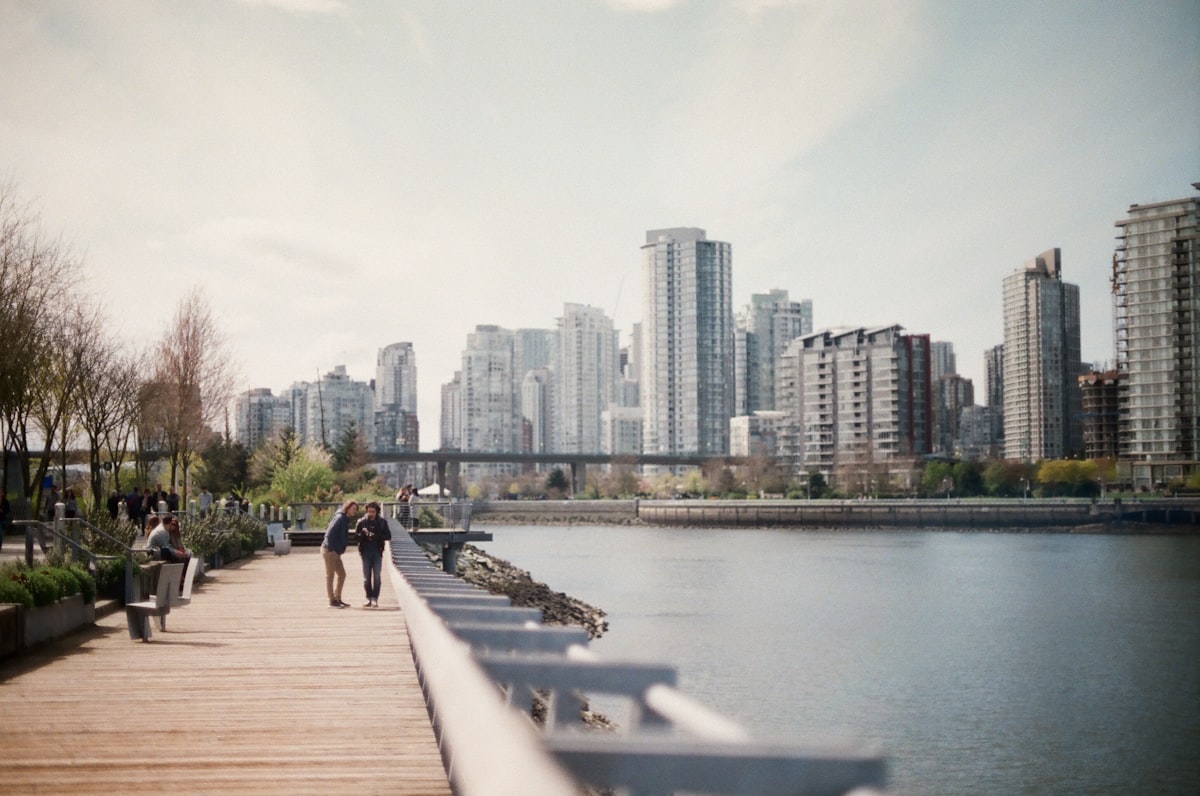 two women walking on brown dock near body of water related to Exploring the Charm of Vancouver's Bed and Breakfasts