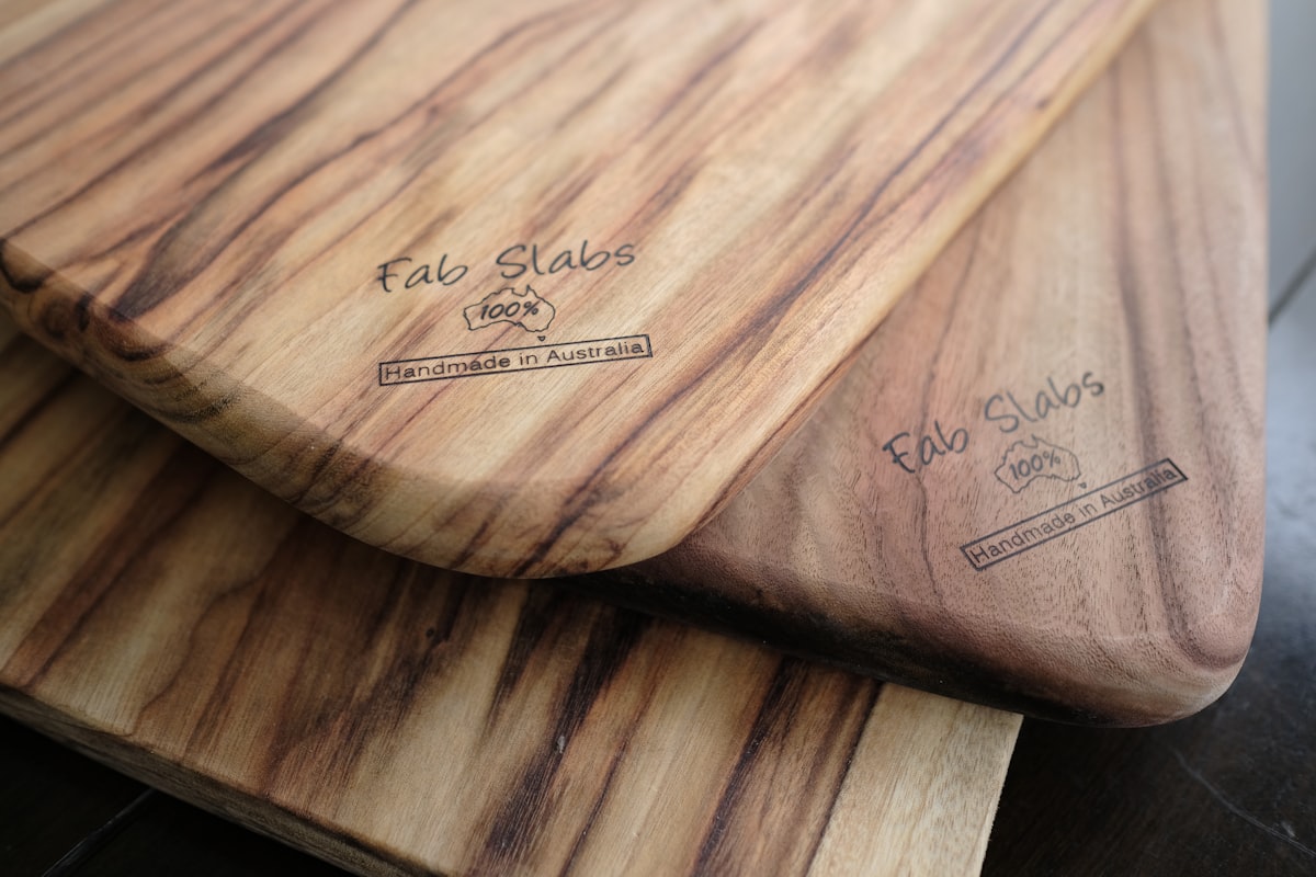 two wooden cutting boards sitting on top of a table related to Elevate Your Home Decor with Teak Sideboards for Sale
