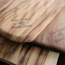 two wooden cutting boards sitting on top of a table related to Elevate Your Home Decor with Teak Sideboards for Sale