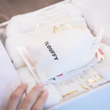Unboxing present gift box for dog mom related to Treasured Essentials: Gold Nursery Bedding for the Little One