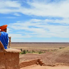 unknown person sitting outdoors related to Cozying Up with Red Clay Chiminea: 6 Unique Options to Consider