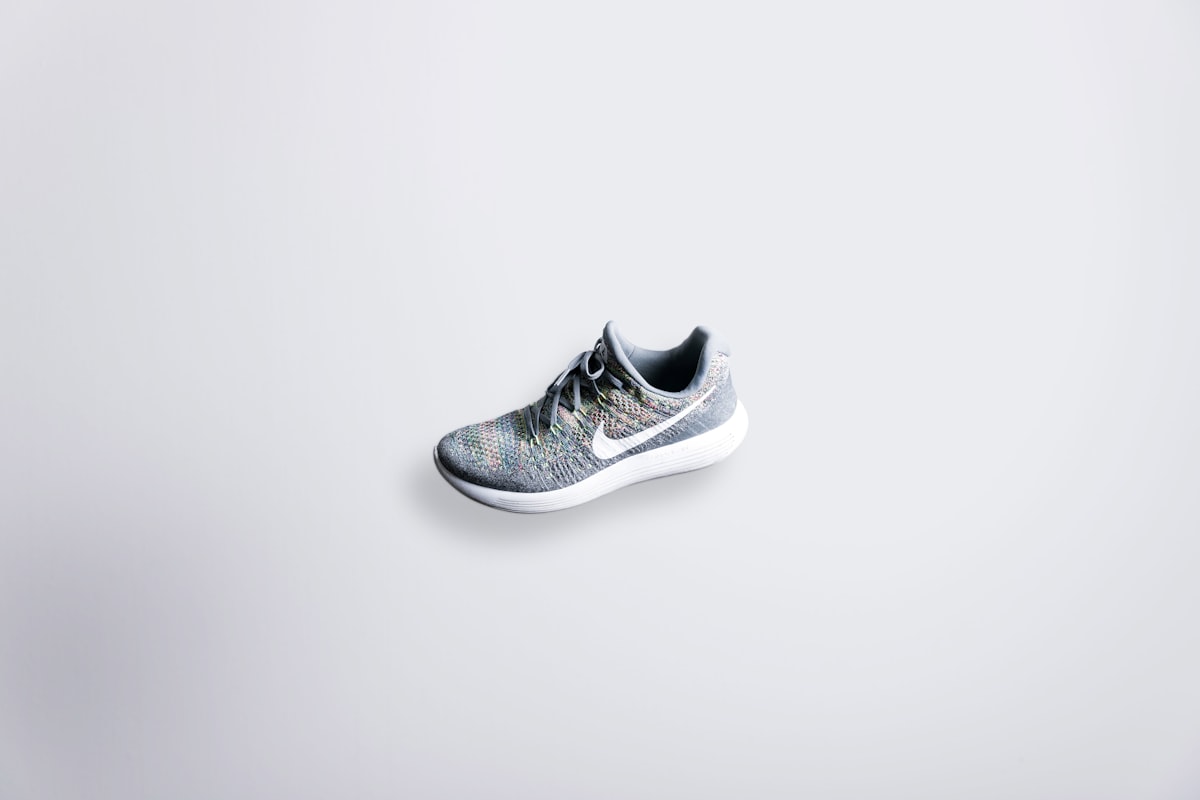 unpaired gray and white Nike Flyknit shoe related to Maximizing Space: Innovative Shoe Storage Solutions for Small Entryways