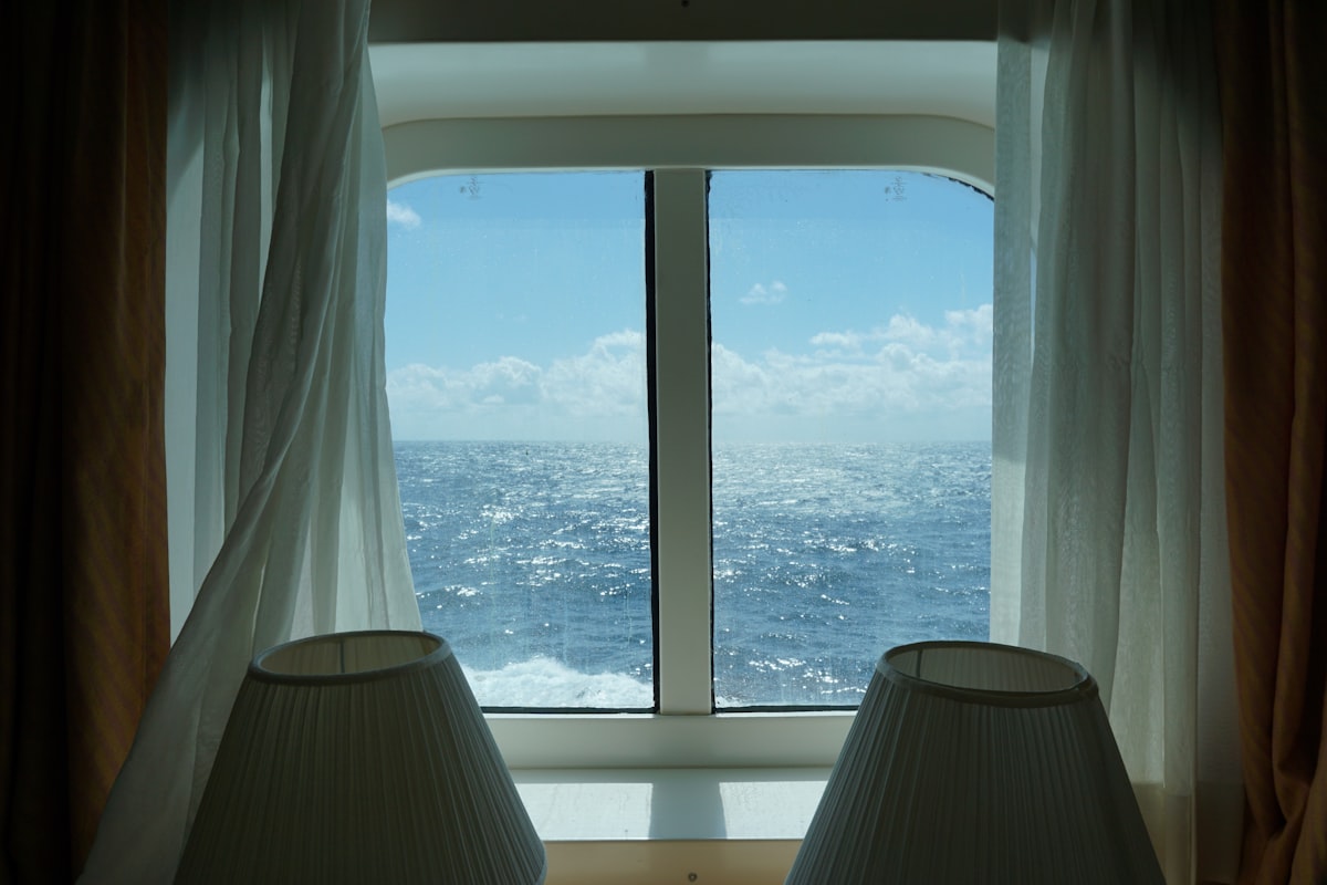 View of ocean out of ship cabin window related to Nautical Valances Window Treatments