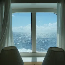 View of ocean out of ship cabin window related to Nautical Valances Window Treatments