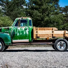 vintage green truck in need of a paint job related to Building Your Own Wood Truck Bed: A Comprehensive Guide