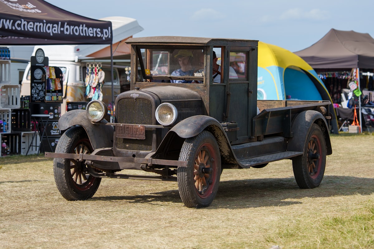 Vintage truck with yellow and blue canopy related to Enhancing Your Truck with a Custom Wooden Bed
