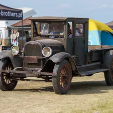 Vintage truck with yellow and blue canopy related to Enhancing Your Truck with a Custom Wooden Bed
