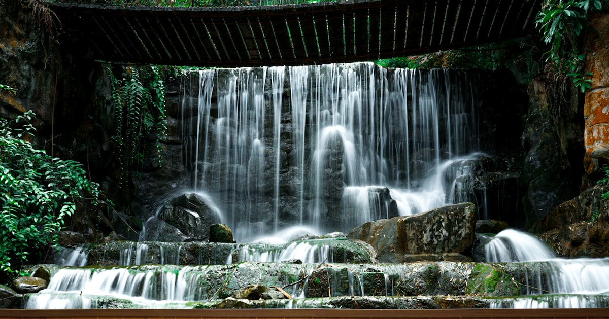 water falls under bridge during daytime related to Cascading Elegance: A Guide to Making Waterfall Valance Curtains