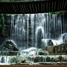 water falls under bridge during daytime related to Cascading Elegance: A Guide to Making Waterfall Valance Curtains