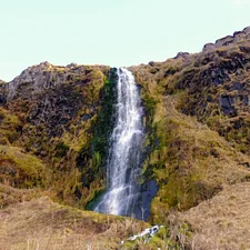 waterfalls in the middle of green and brown mountain related to How to Hang a Waterfall Valance: A Comprehensive Guide