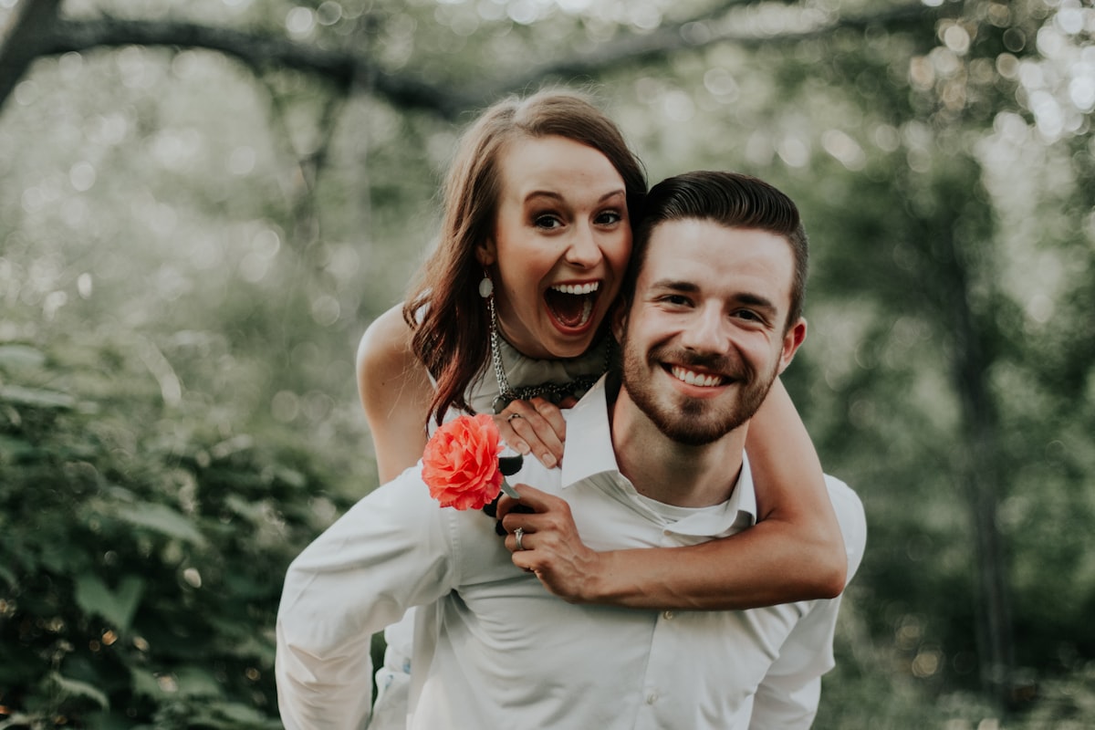 We were walking through a park with trails leading into the forests, when we saw this breathtaking coral flower… my sister ran and got it and jumped on her husbands back… right then and there is where is captured this priceless image. related to The Art of Romantic Intimacy: A Guide to Winning a Woman's Heart in Bed