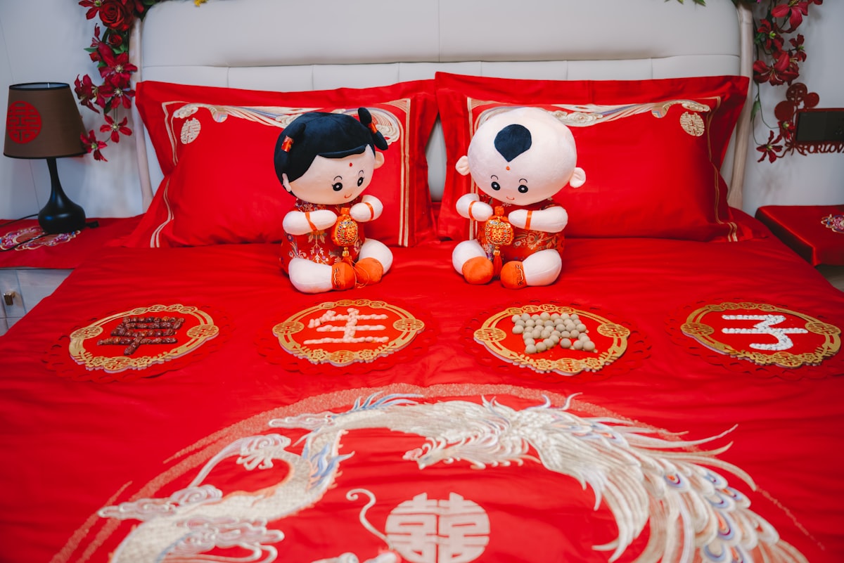 Wedding bed decor with dolls, pillowcases and bedding. related to Cozy Up with Red Crib Bedding: A Guide to Choosing the Best