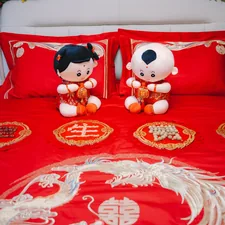 Wedding bed decor with dolls, pillowcases and bedding. related to Cozy Up with Red Crib Bedding: A Guide to Choosing the Best