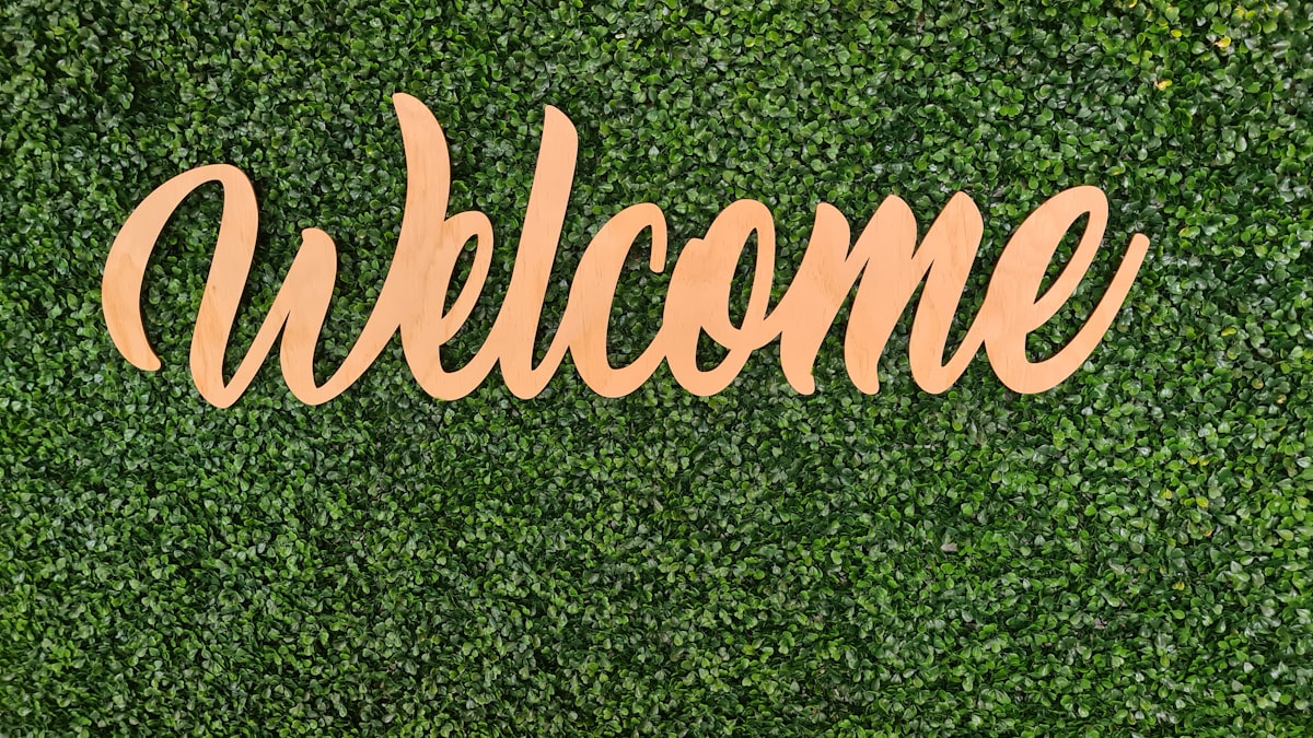 Welcome sign on green leaf background  related to Welcome to Iron Haven - Cast Iron Chimineas for Sale