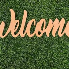 Welcome sign on green leaf background  related to Welcome to Iron Haven - Cast Iron Chimineas for Sale