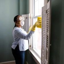 When renovating a home, you should use a damp sponge or cloth to clean dust collected on a window sill, as the dust may contain asbestos or lead-based paint. Home maintenance is an ongoing process for any homeowner, and here we see an African-American woman’s hand, as it steadied the window’s sash in preparation of a cleaning of the window and its frame. See PHIL 11460, and 11461, for a broader view of this activity. related to Elevate Your Window Style with a Curtain with Valance
