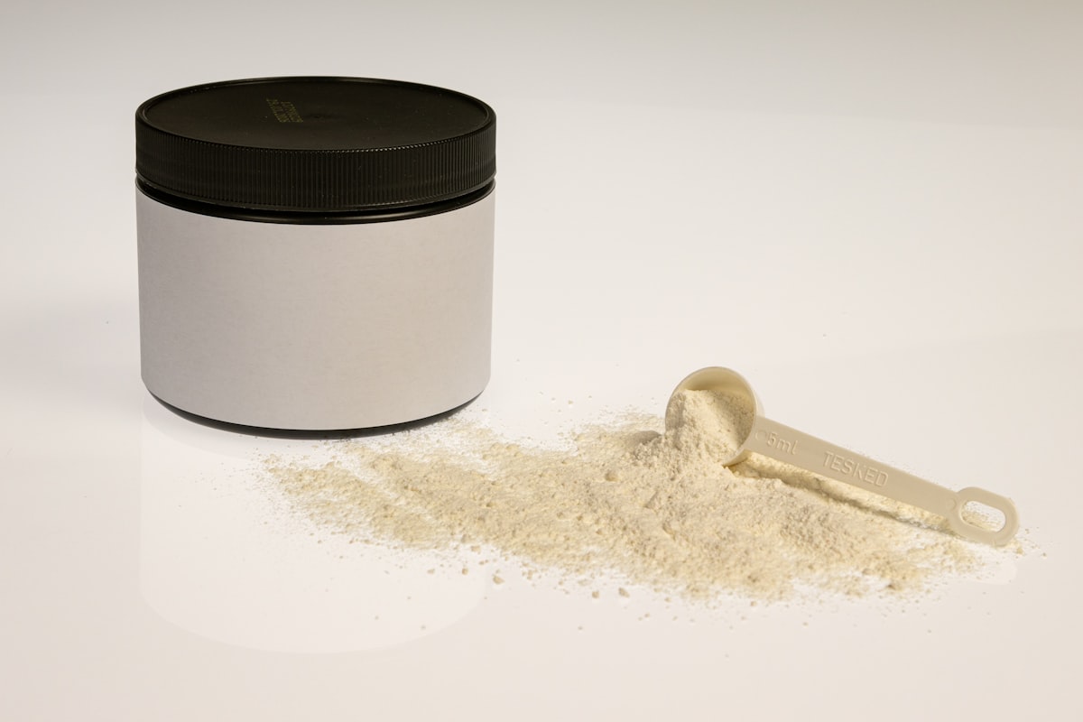 Whey protein vanilla powder in jar with close view measuring scoop, gym nutrition related to How Diatomaceous Earth Can Help You Defeat Bed Bugs Naturally
