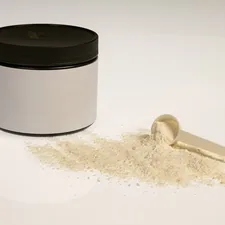 Whey protein vanilla powder in jar with close view measuring scoop, gym nutrition related to How Diatomaceous Earth Can Help You Defeat Bed Bugs Naturally