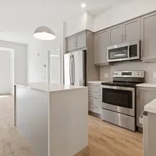 white and black kitchen cabinet related to Your Dream Condo Awaits: Spacious 2 Bed 2 Bath Gem