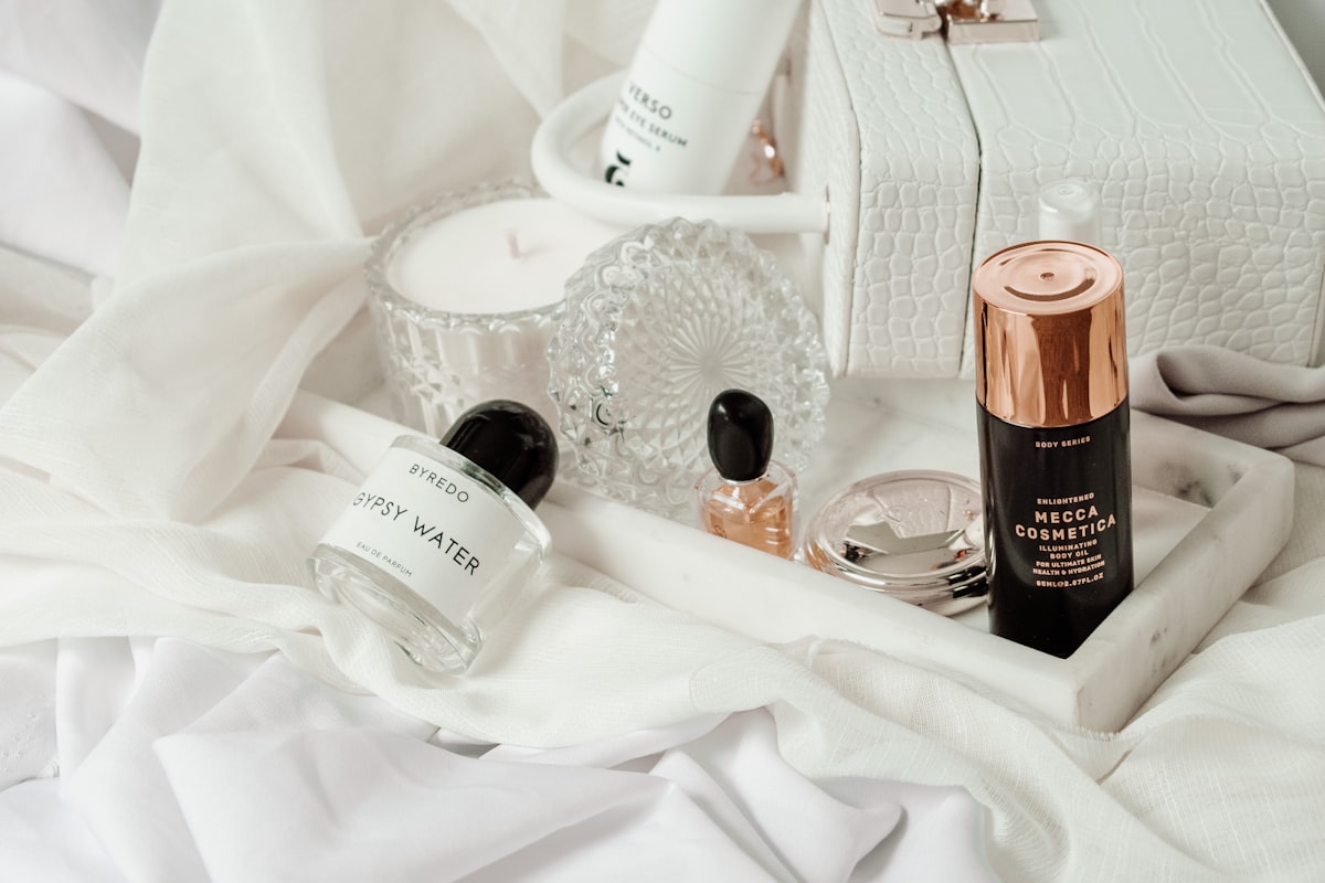 white and brown plastic bottle on white textile related to Ultimate Guide to Choosing the Perfect Bed Bath and Beyond Makeup Vanity